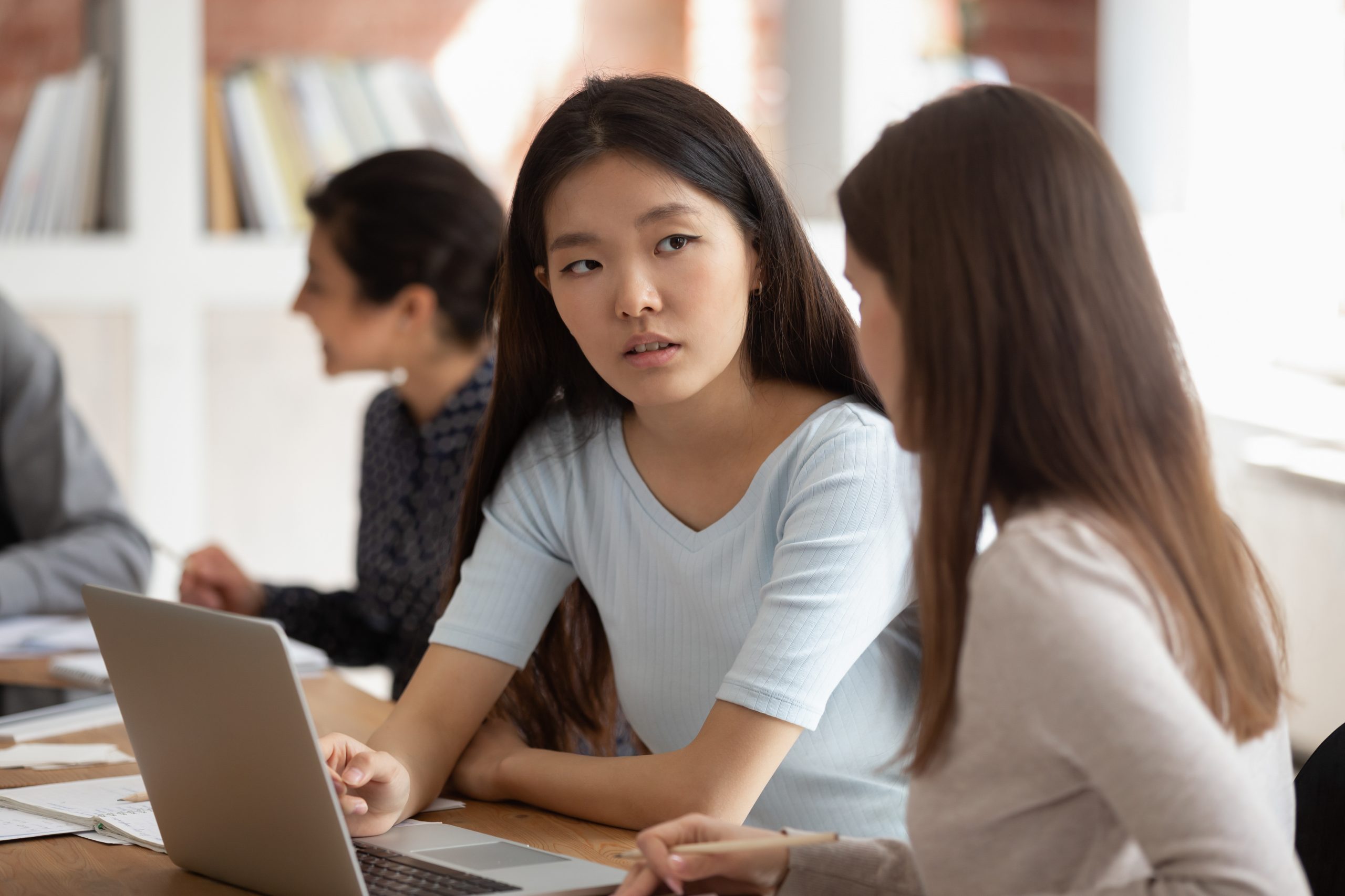 Concentrated,Asian,Female,Student,Listening,To,Teammate,New,Theme,Explanation.