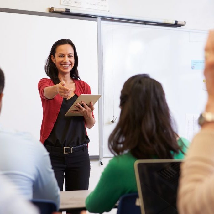 Teacher,With,Tablet,And,Students,At,An,Adult,Education,Class