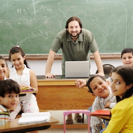teacher-in-front-of-chalboard-with-kids